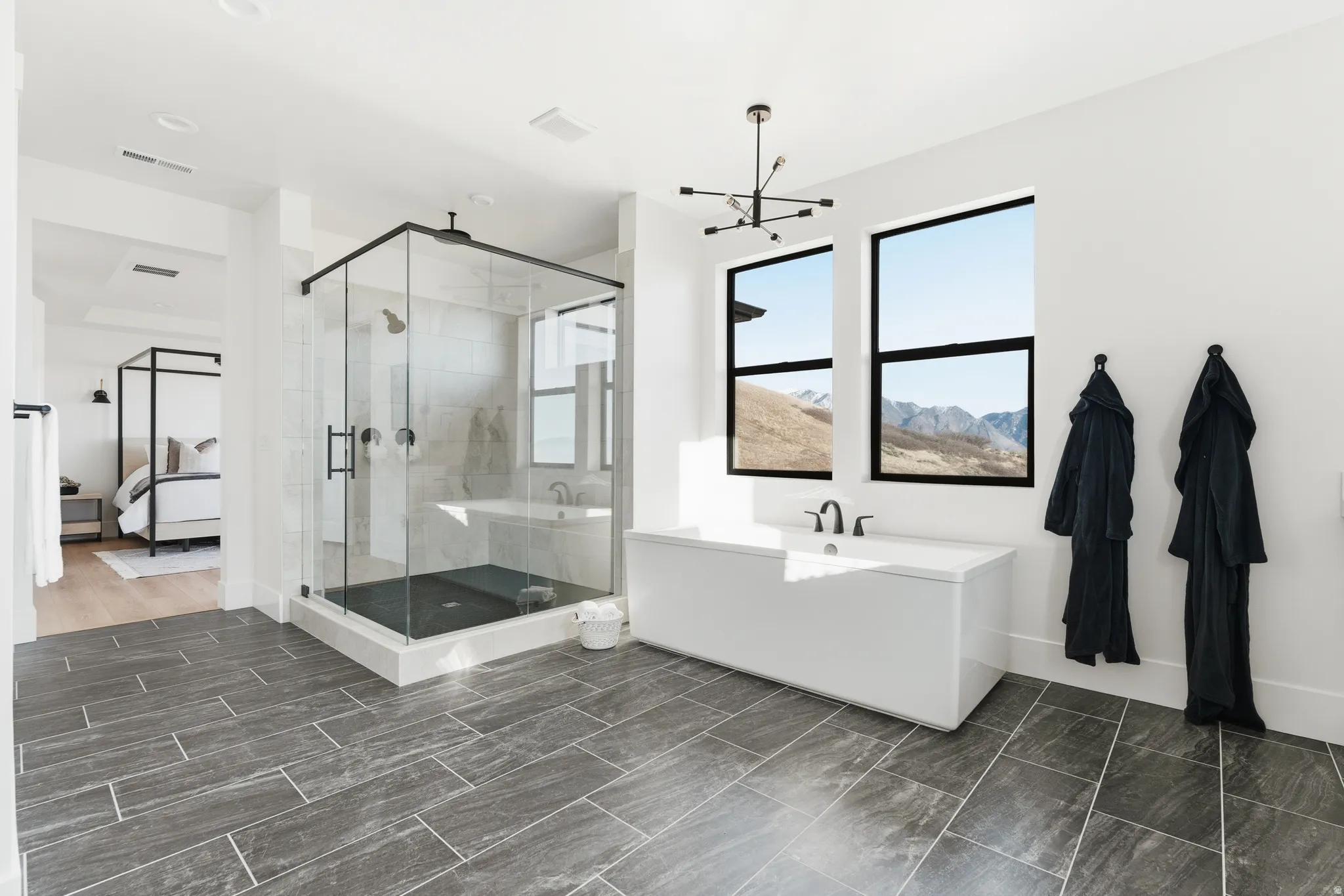 Full bath with ensuite bath, a tub, and a shower stall