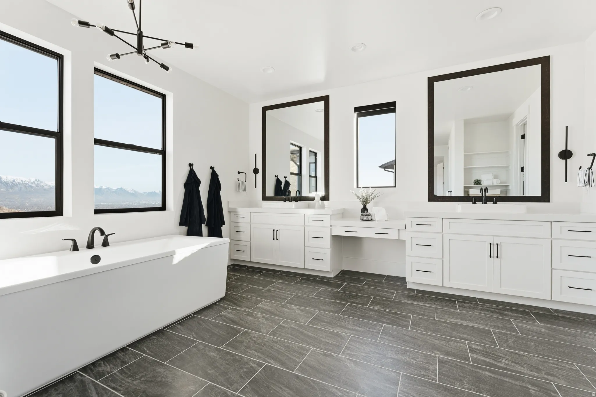 Bathroom with vanity, a freestanding bath, and recessed lighting