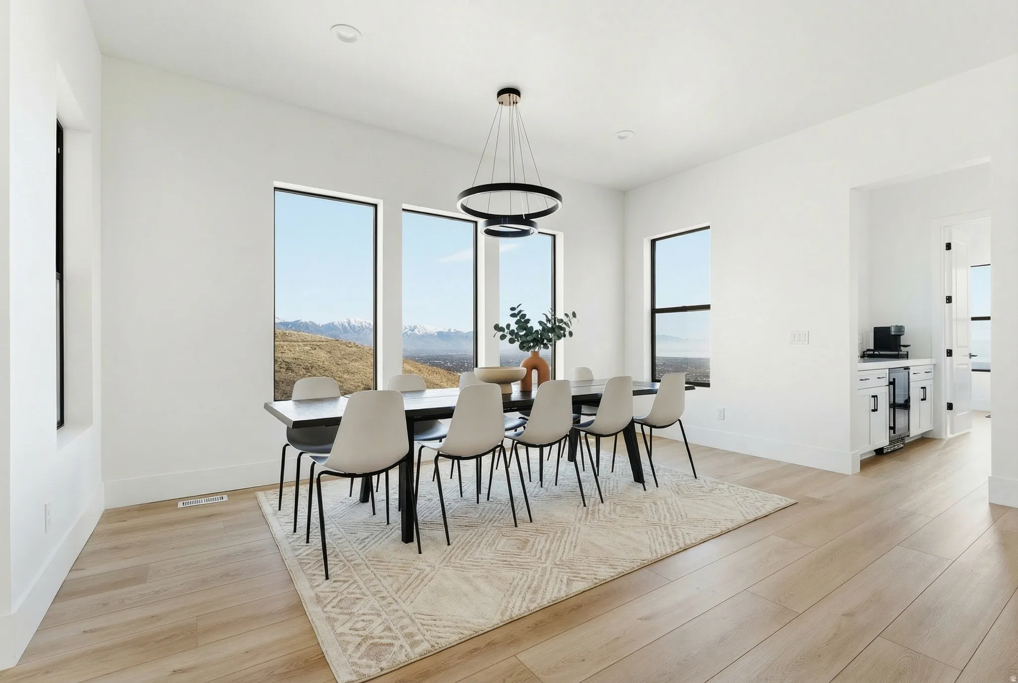 Dining space with light wood-style floors - Digitally Staged
