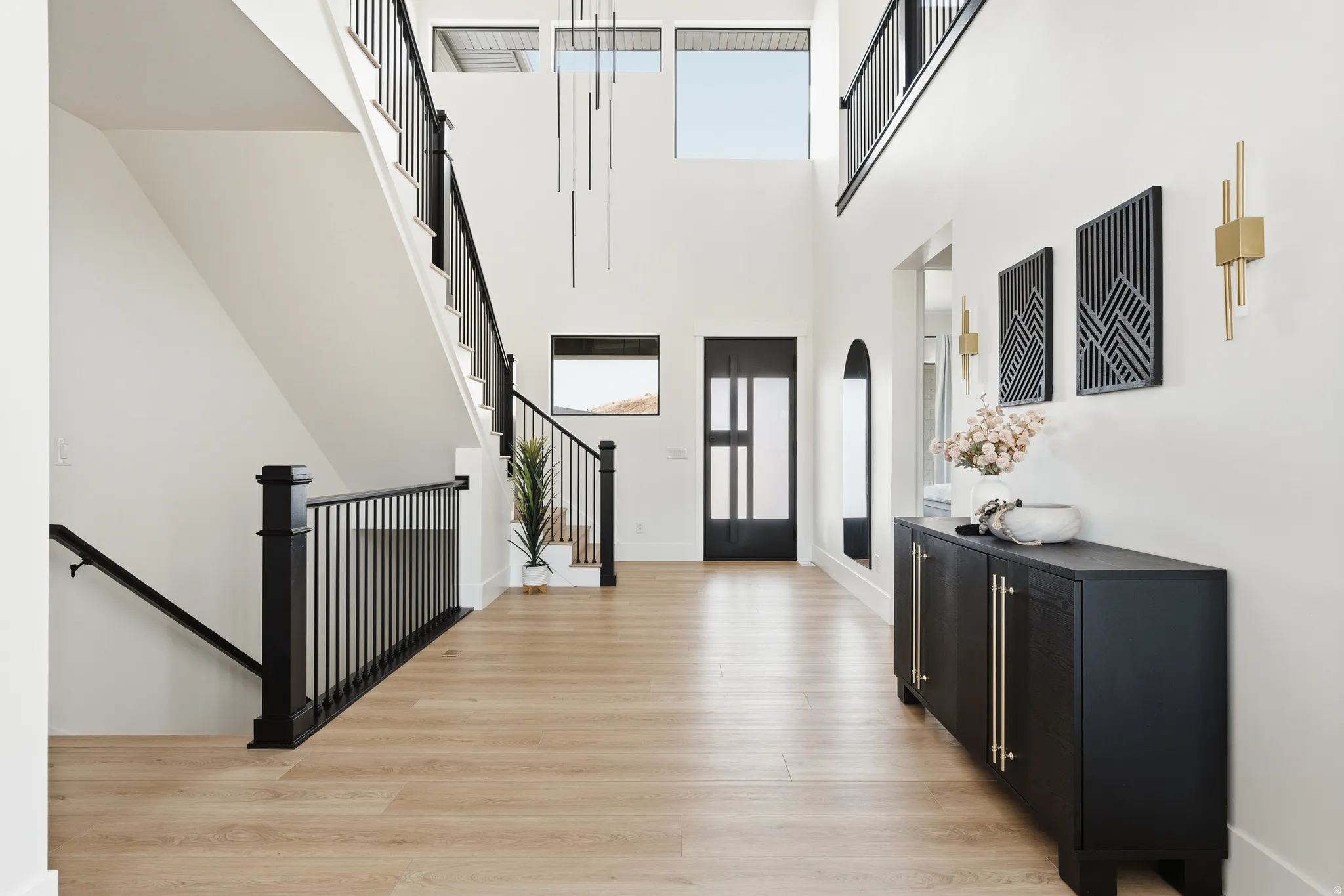 Foyer entrance featuring light wood finished floors and a high ceiling