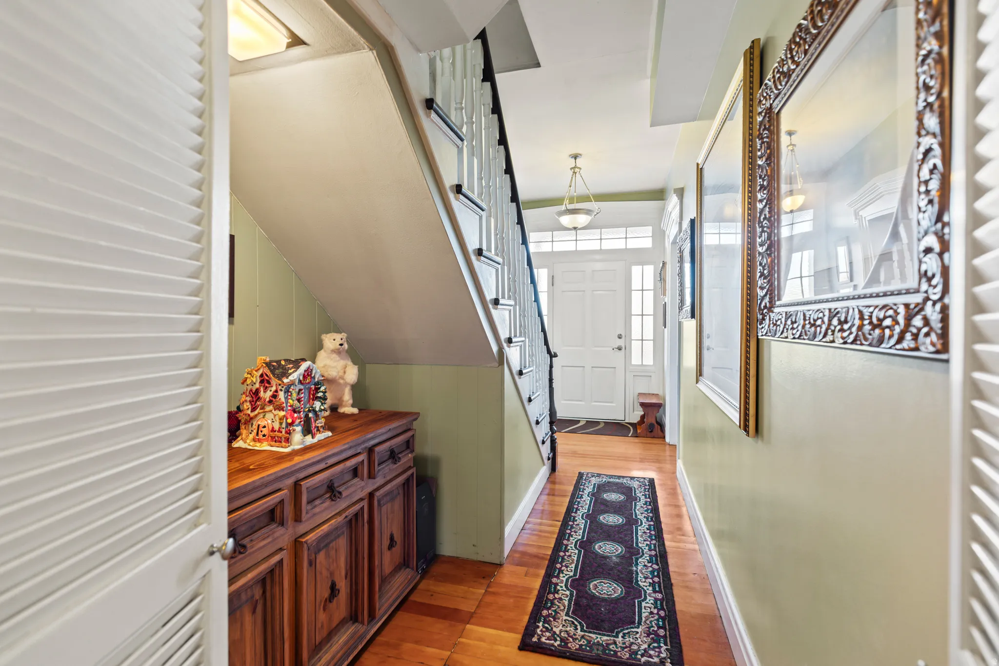 Doorway to outside featuring stairs and wood finished floors