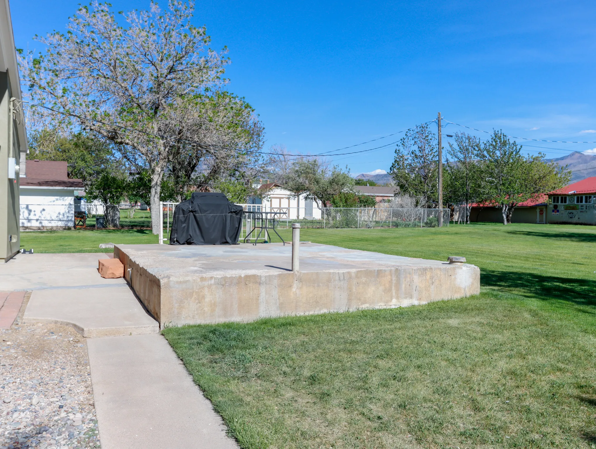 Expansive concrete patio with a raised foundation