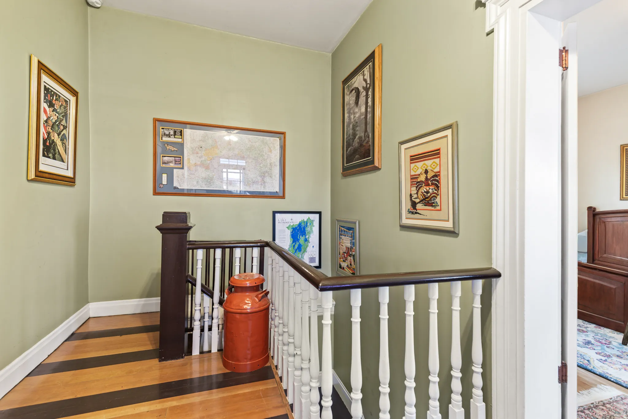 Stairs with wood finished floors and baseboards