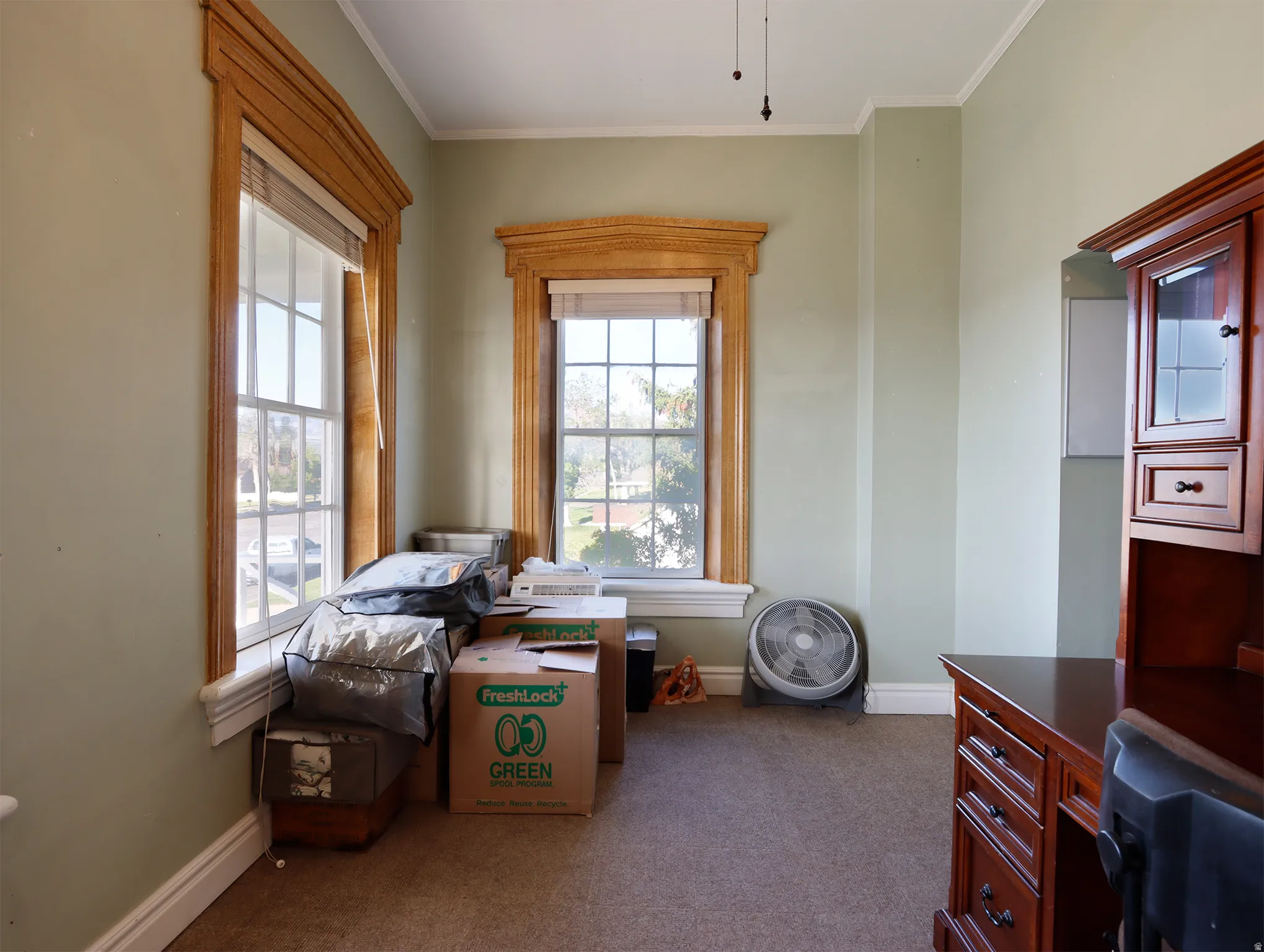 Two double-hung windows with decorative wood trim