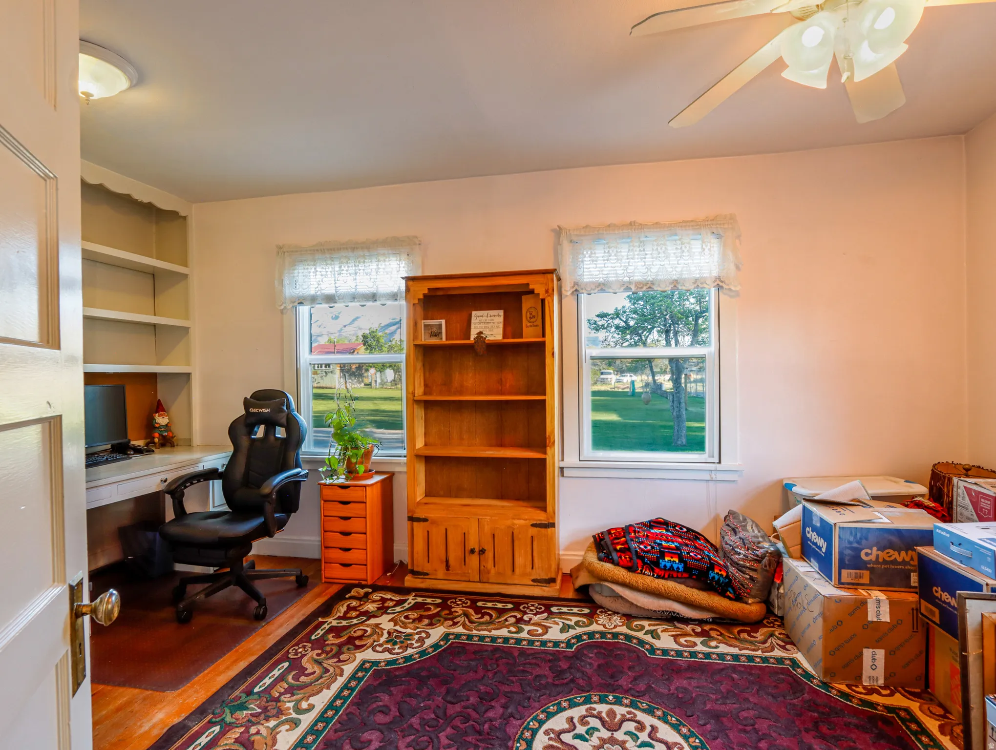 Room featuring wood-finish flooring and a ceiling fan