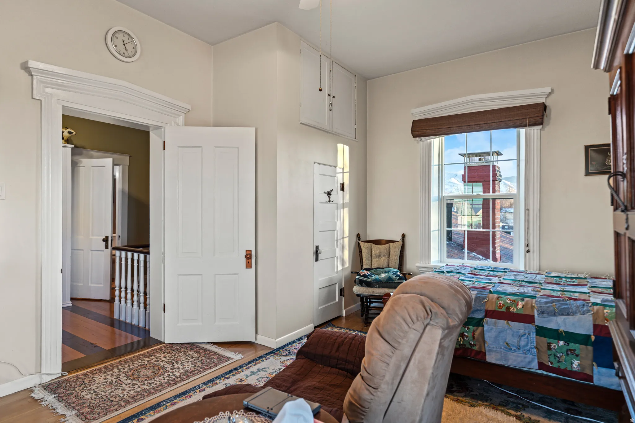 Bedroom with wood finished floors and baseboards
