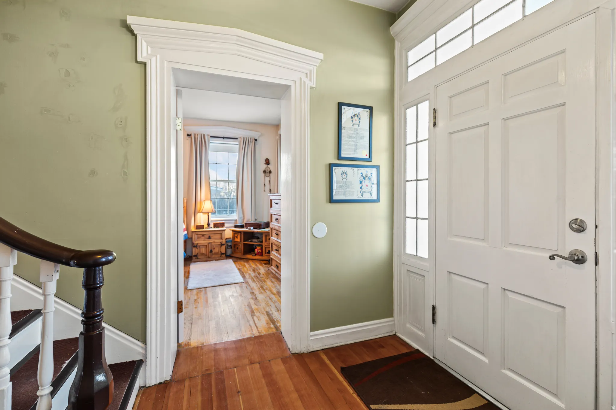 Entrance foyer with dark wood-type flooring and stairs