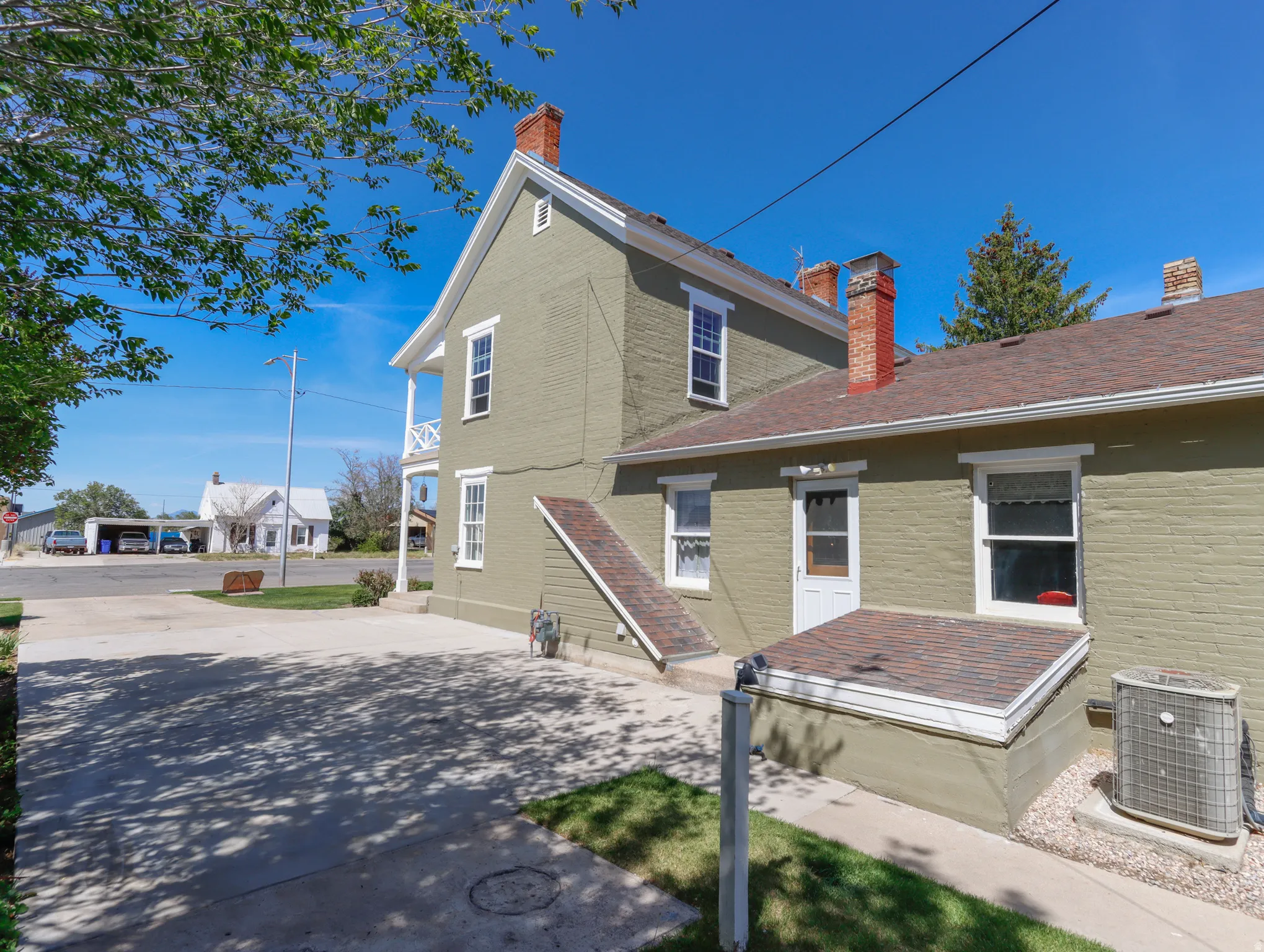 Exterior siding in a muted green hue complemented by white trim