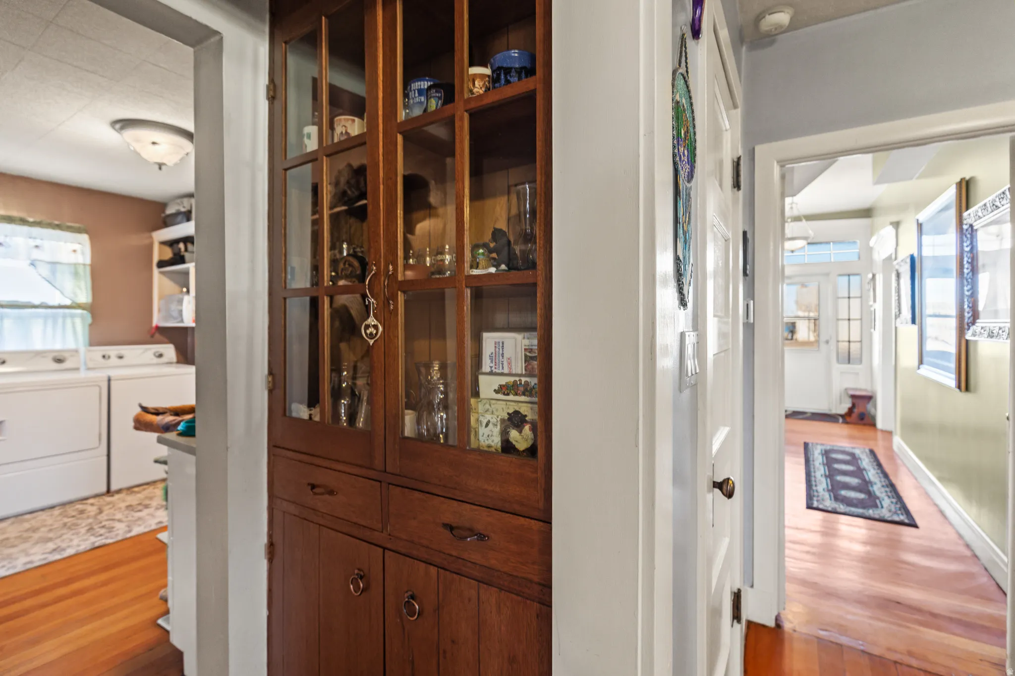 Detailed view of wood finished floors and washer and clothes dryer