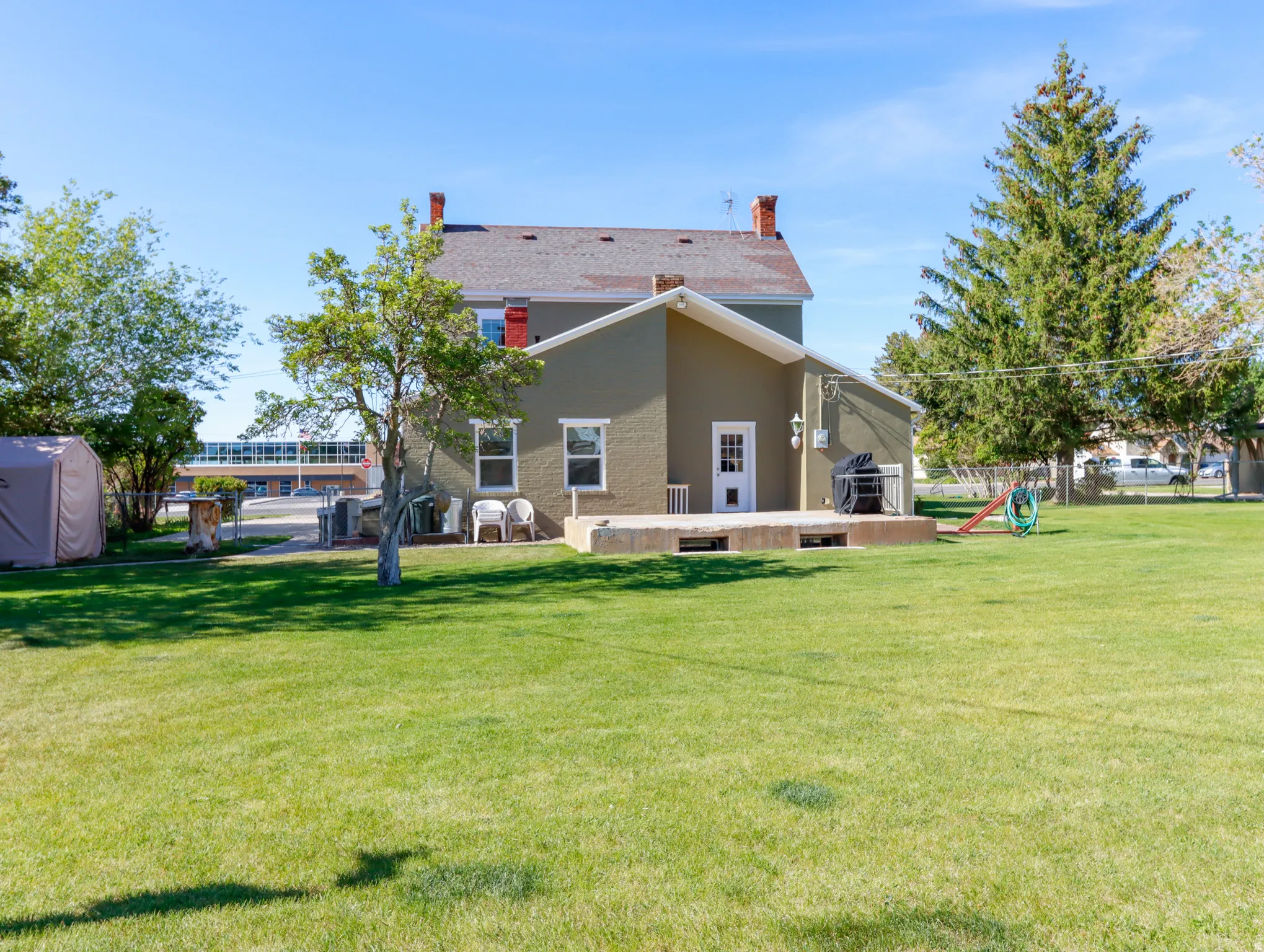 Expansive green lawn with mature trees