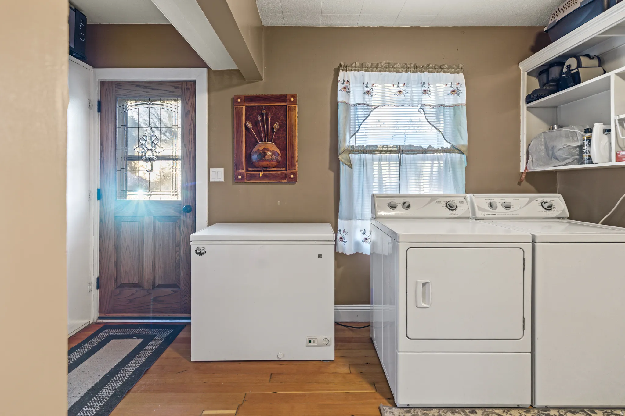Laundry area featuring separate washer and dryer and light wood-style floors