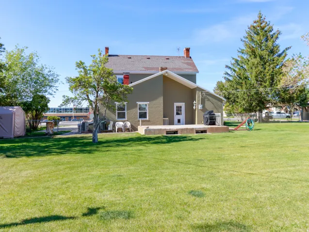 Expansive green lawn with mature trees