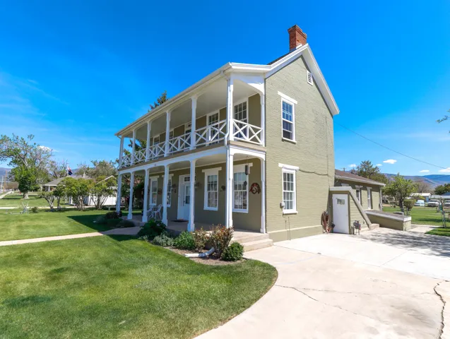 Two-story residence featuring a dual-level covered porch with decorative railings