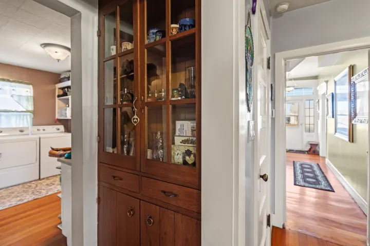 Detailed view of wood finished floors and washer and clothes dryer