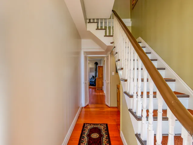 Hardwood flooring in a rich cherry finish extending through a hallway