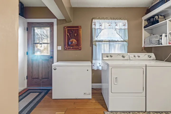 Laundry area featuring separate washer and dryer and light wood-style floors