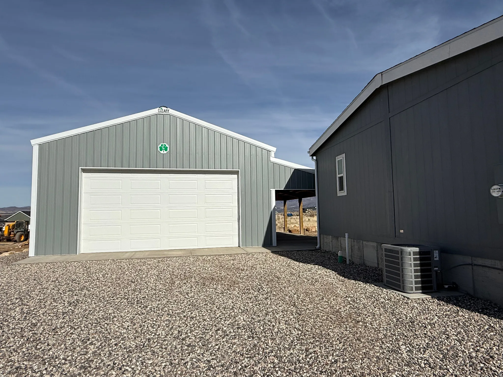 Detached garage with gravel driveway