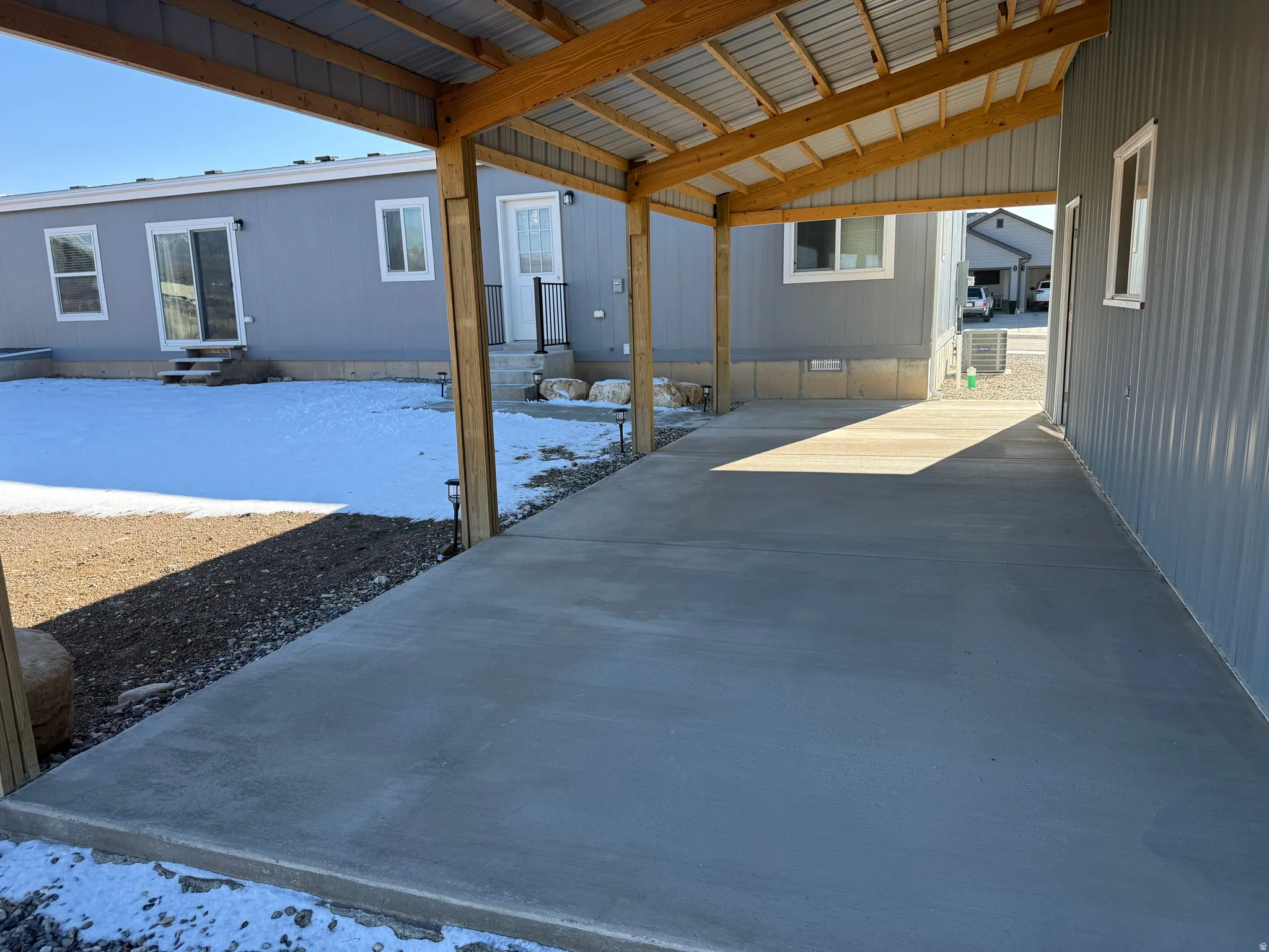Snow covered patio featuring entry steps