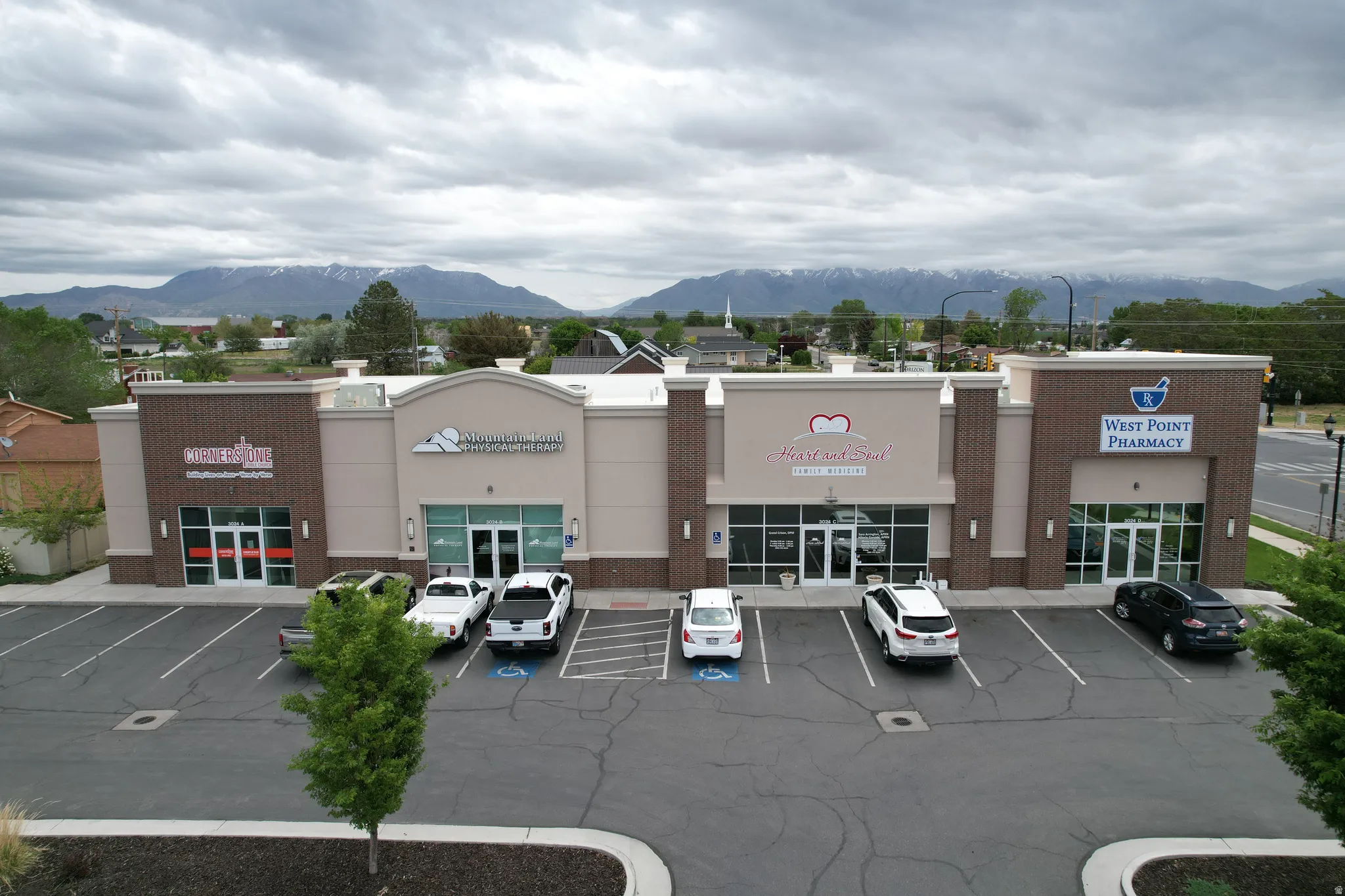 View of commercial property with a mountain view and uncovered parking