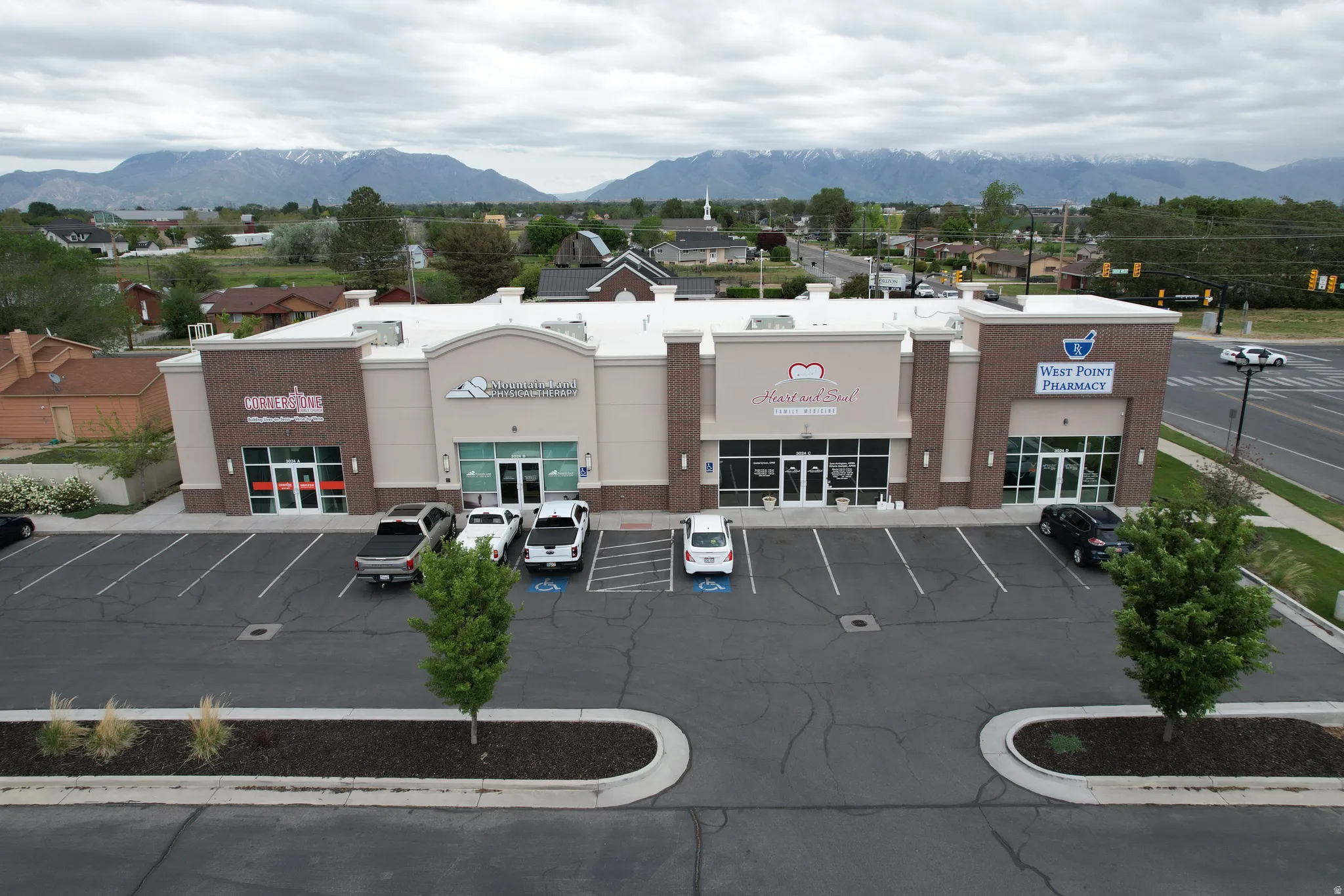 View of commercial location with a mountain view and uncovered parking