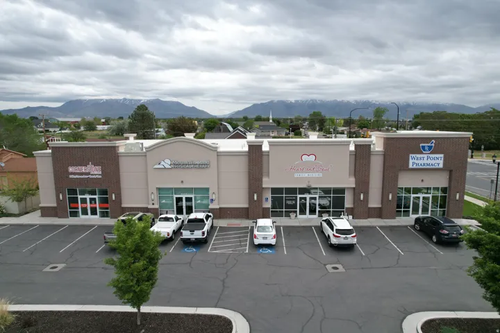View of commercial property with a mountain view and uncovered parking