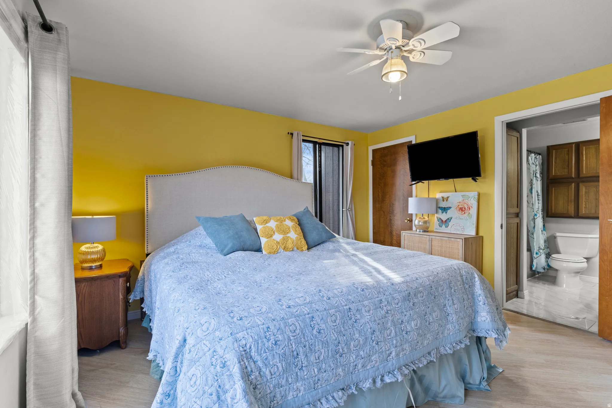 Bedroom featuring ceiling fan, a closet, and wood finished floors