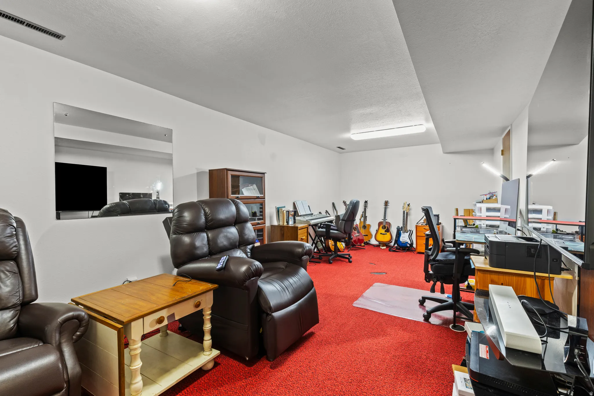 Miscellaneous room with carpet flooring and a textured ceiling