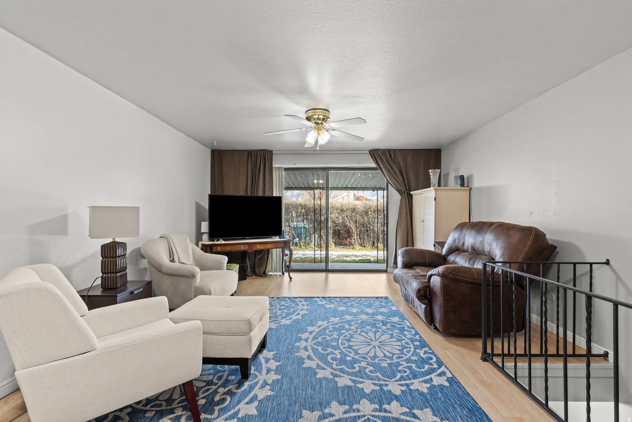 Living room featuring wood finished floors and ceiling fan