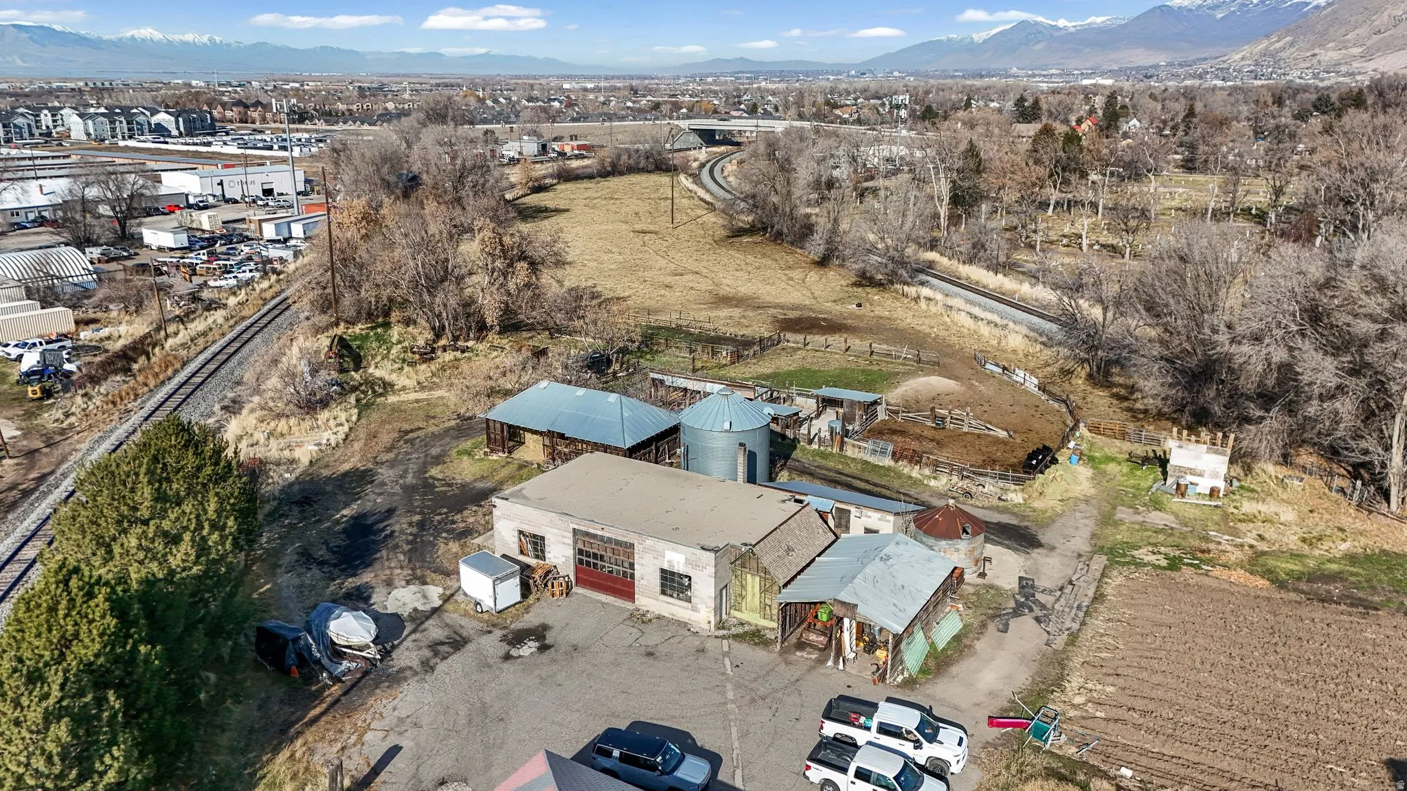 Aerial view of property and surrounding area with a mountain backdrop