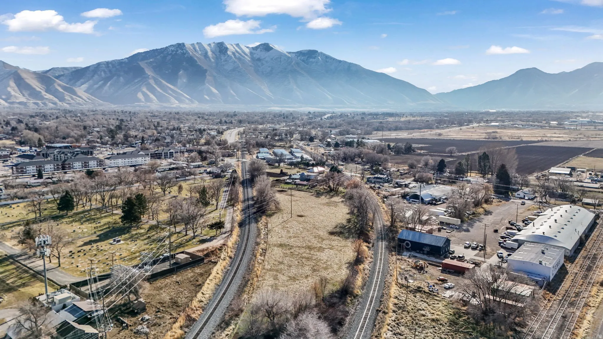 Aerial view of property and surrounding area with a mountain backdrop