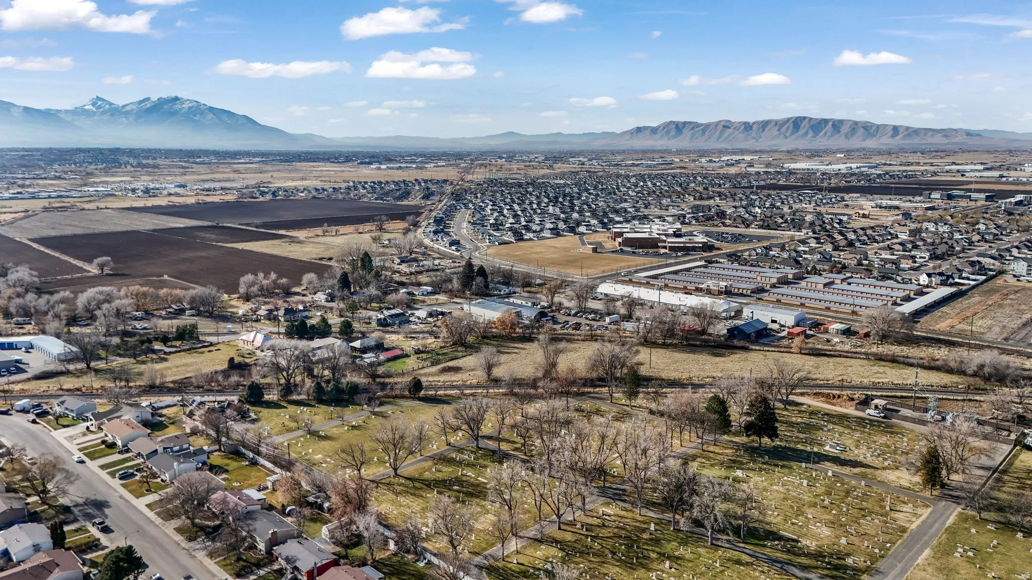 Aerial view of property's location featuring mountains and nearby suburban area