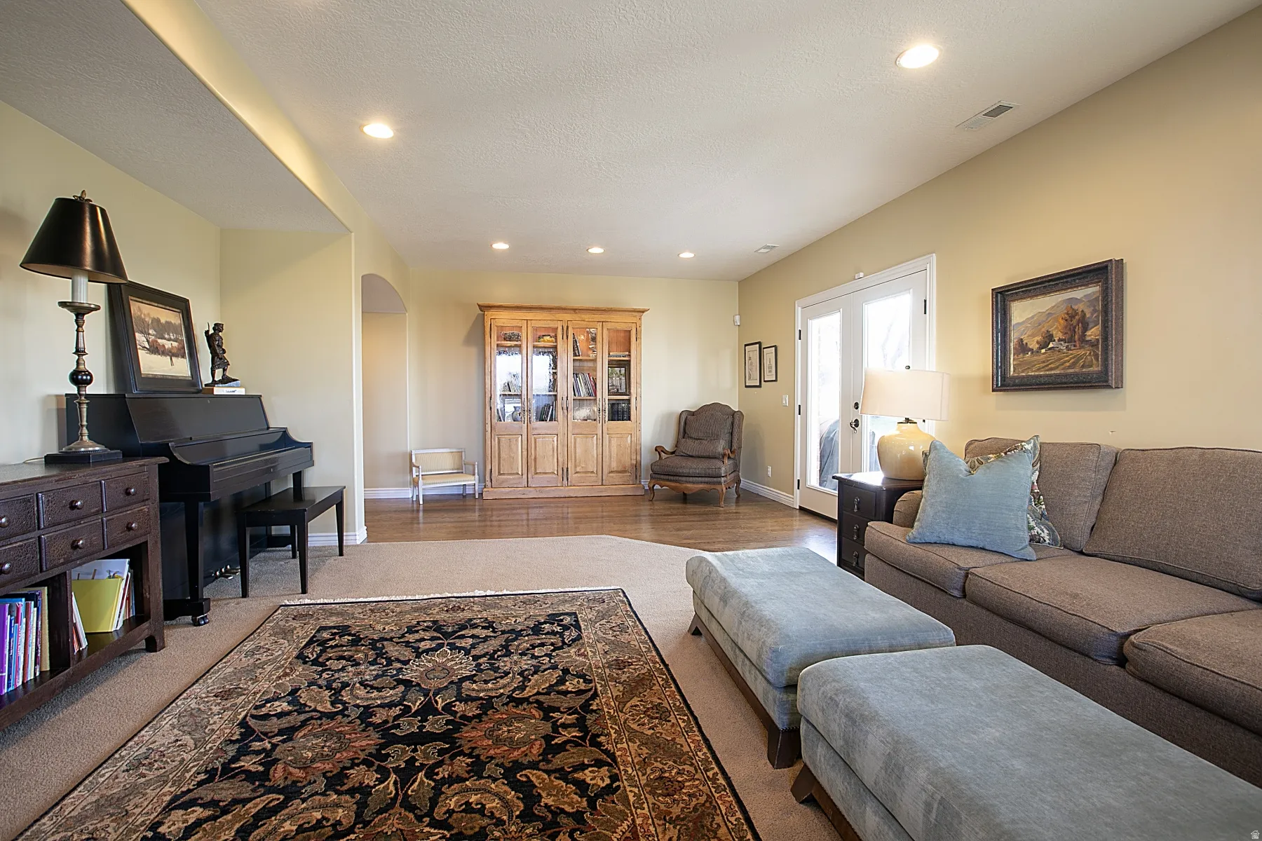 Living room with arched walkways and recessed lighting
