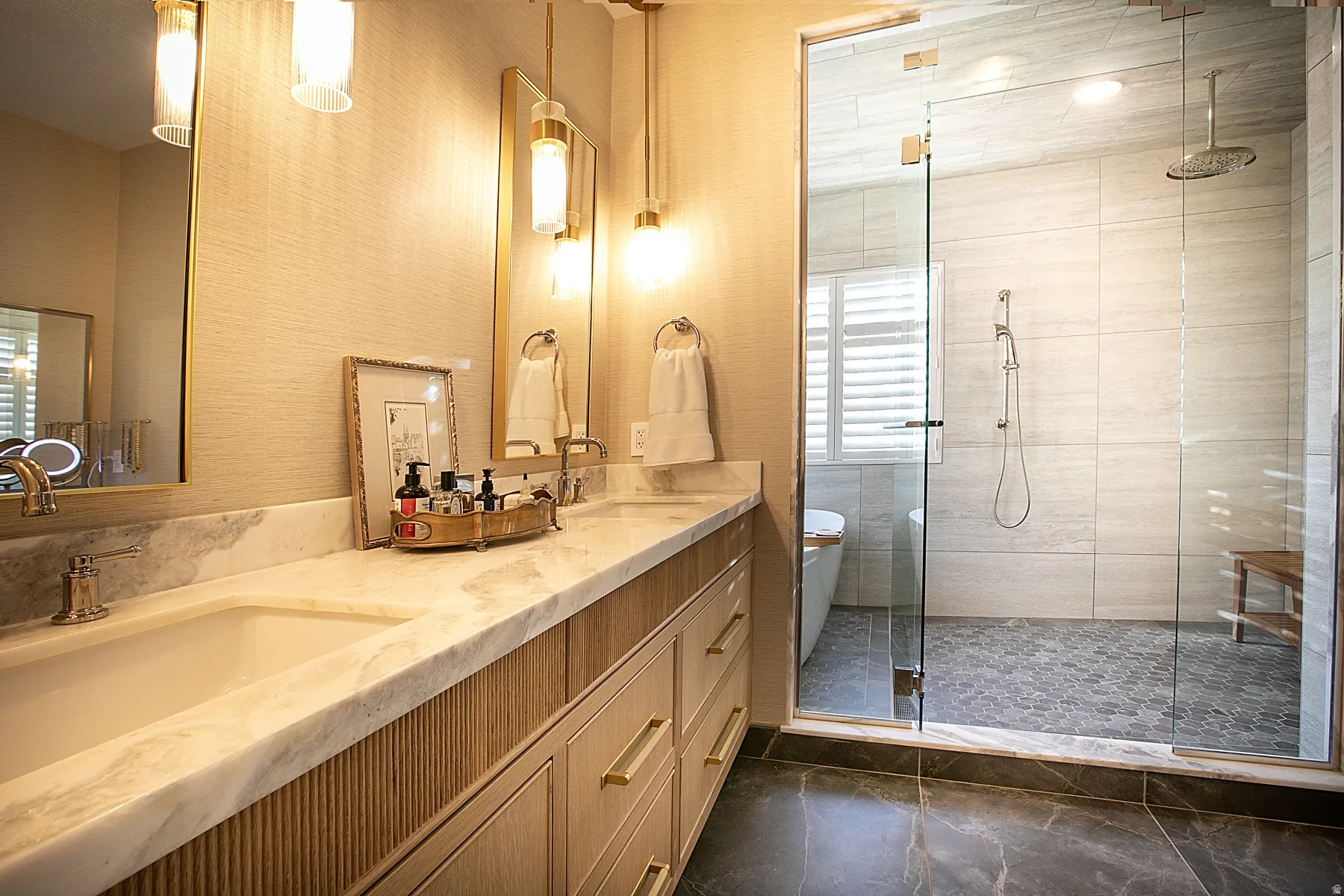 Bathroom with a stall shower, double vanity, and a freestanding bath