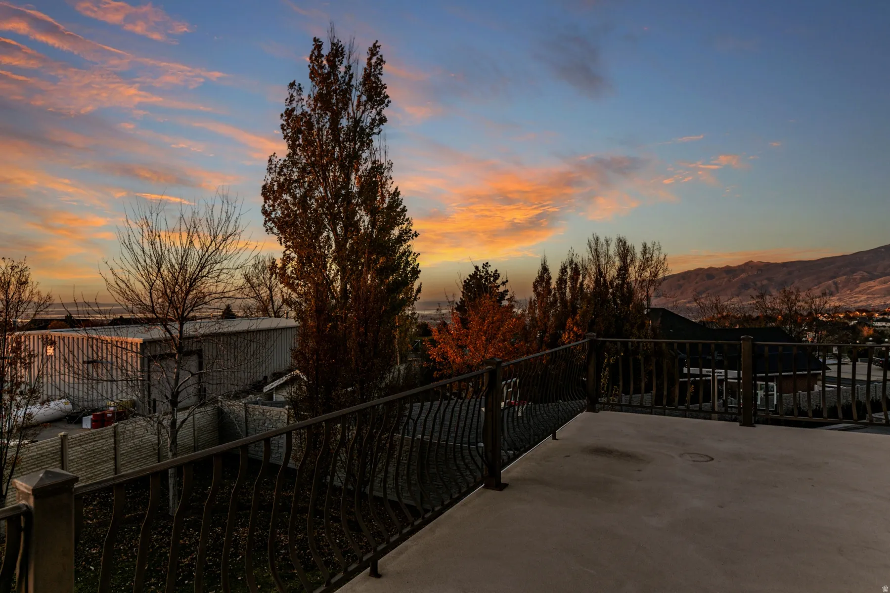 Patio terrace at dusk featuring a patio and a mountain view