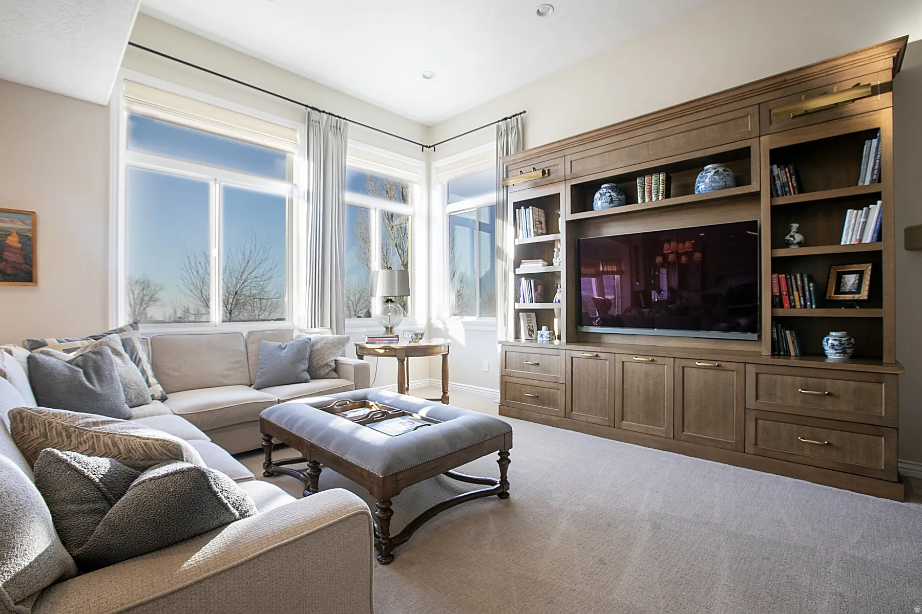 Living area with light carpet and baseboards