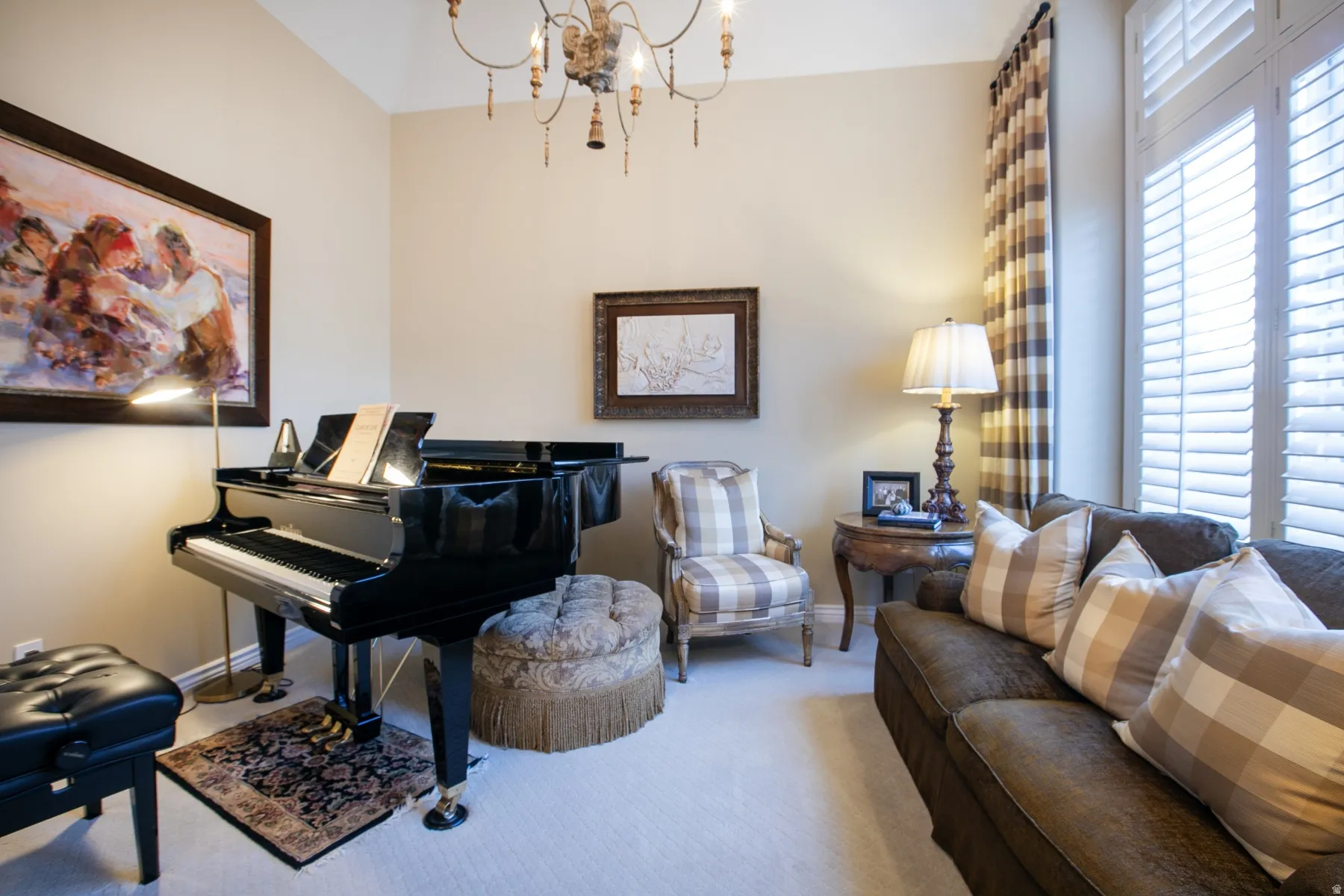Sitting room with a chandelier and carpet flooring