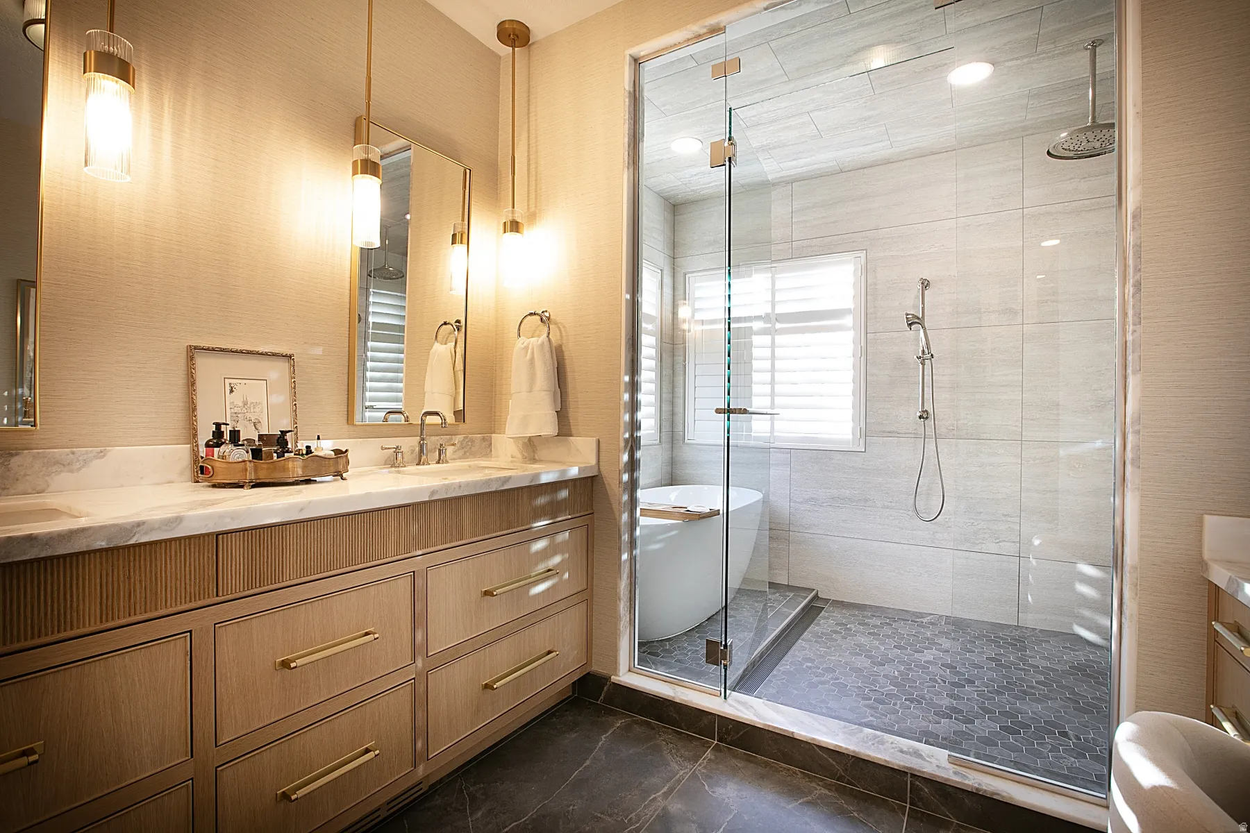 Full bath featuring double vanity, a stall shower, and a soaking tub
