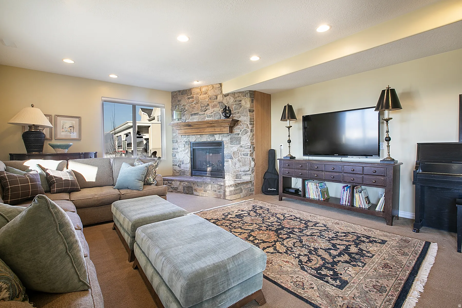Living area featuring a fireplace, carpet, and recessed lighting