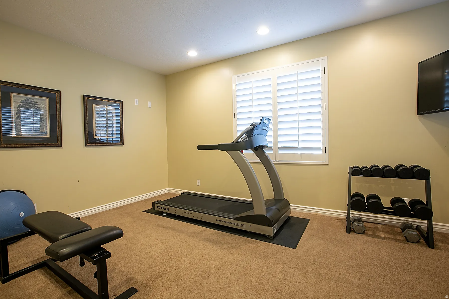 Workout area with carpet floors and recessed lighting