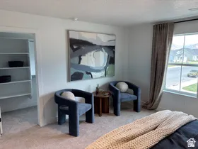 Bedroom with light carpet and a textured ceiling