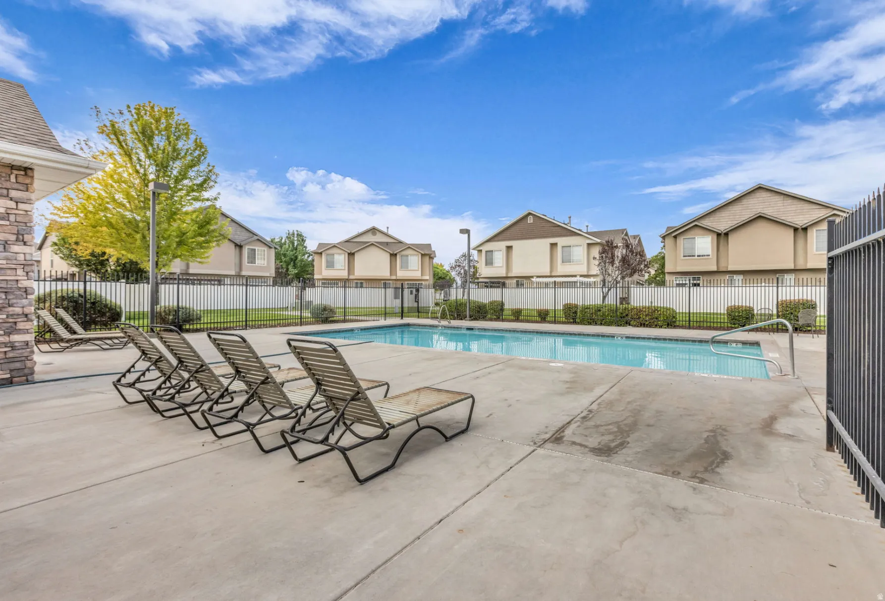 Community pool featuring a patio and a residential view