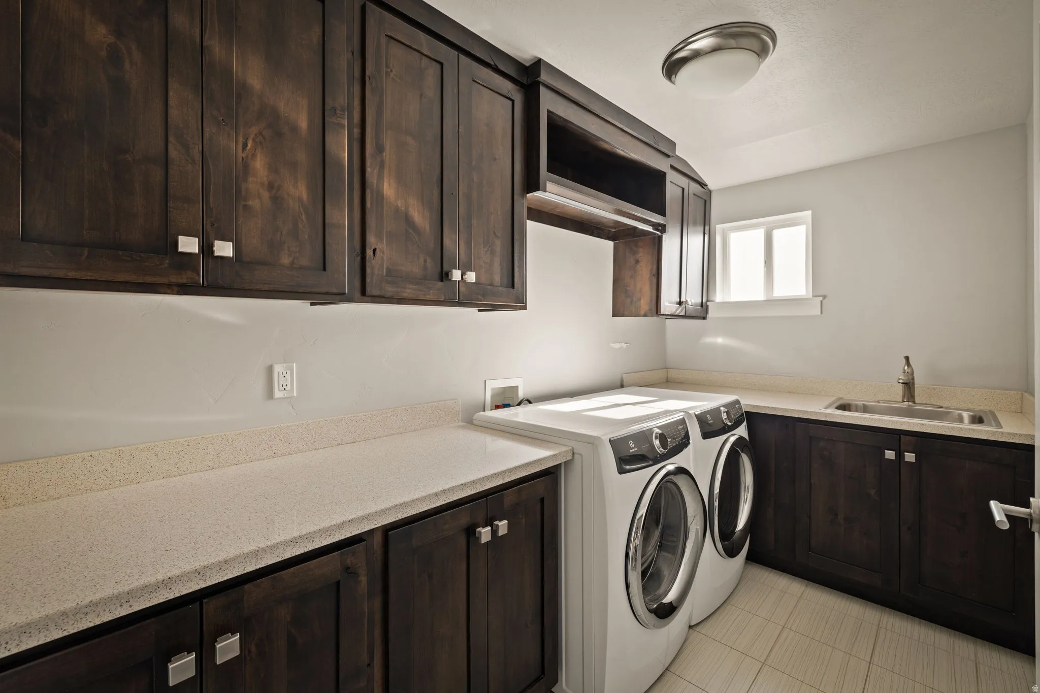 Laundry area featuring washing machine and clothes dryer and cabinet space
