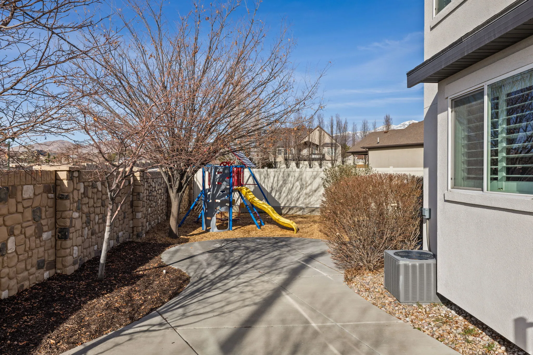 View of play area featuring a fenced backyard