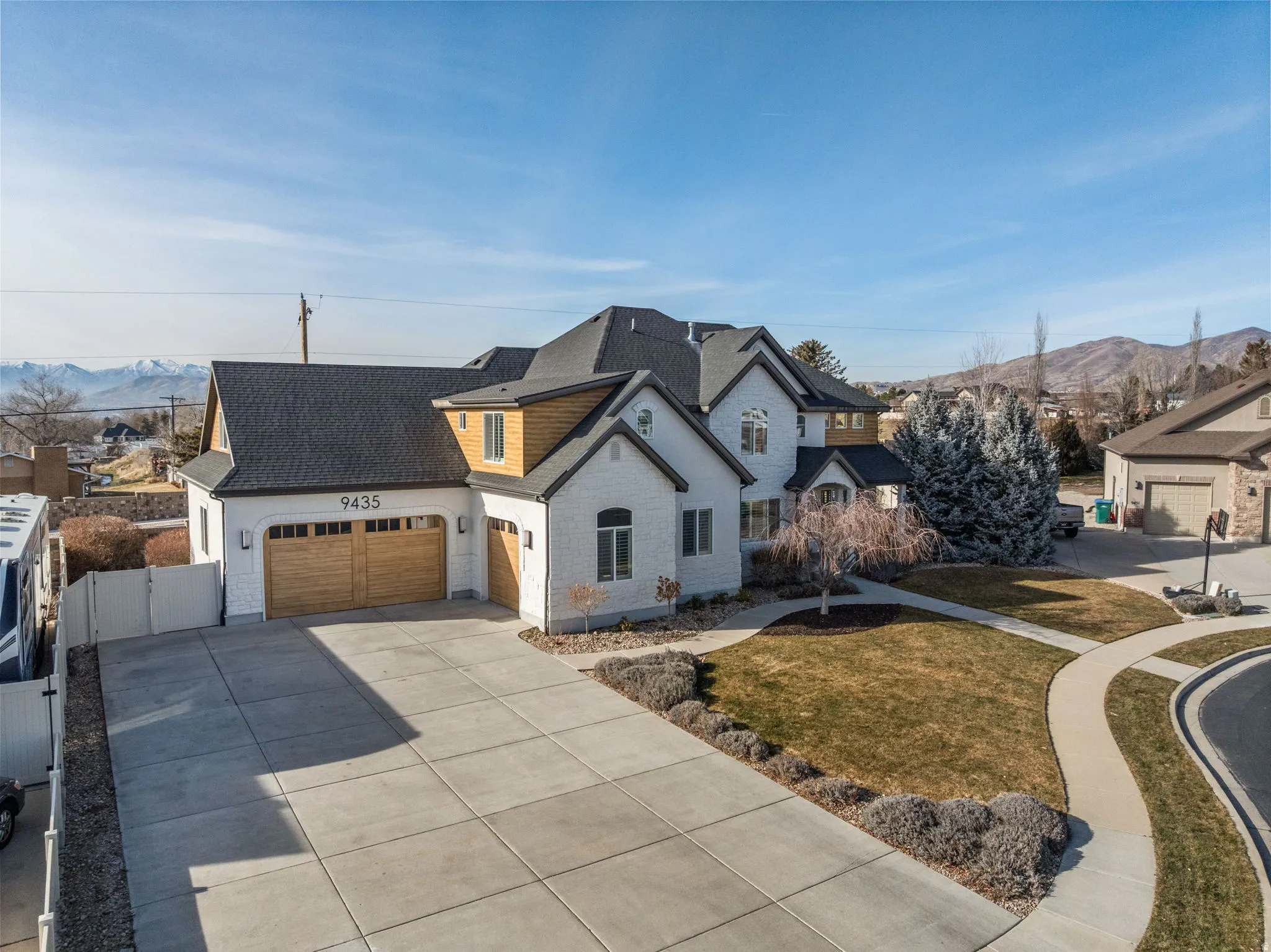 French country style house featuring a mountain view, roof with shingles, driveway, and an attached garage