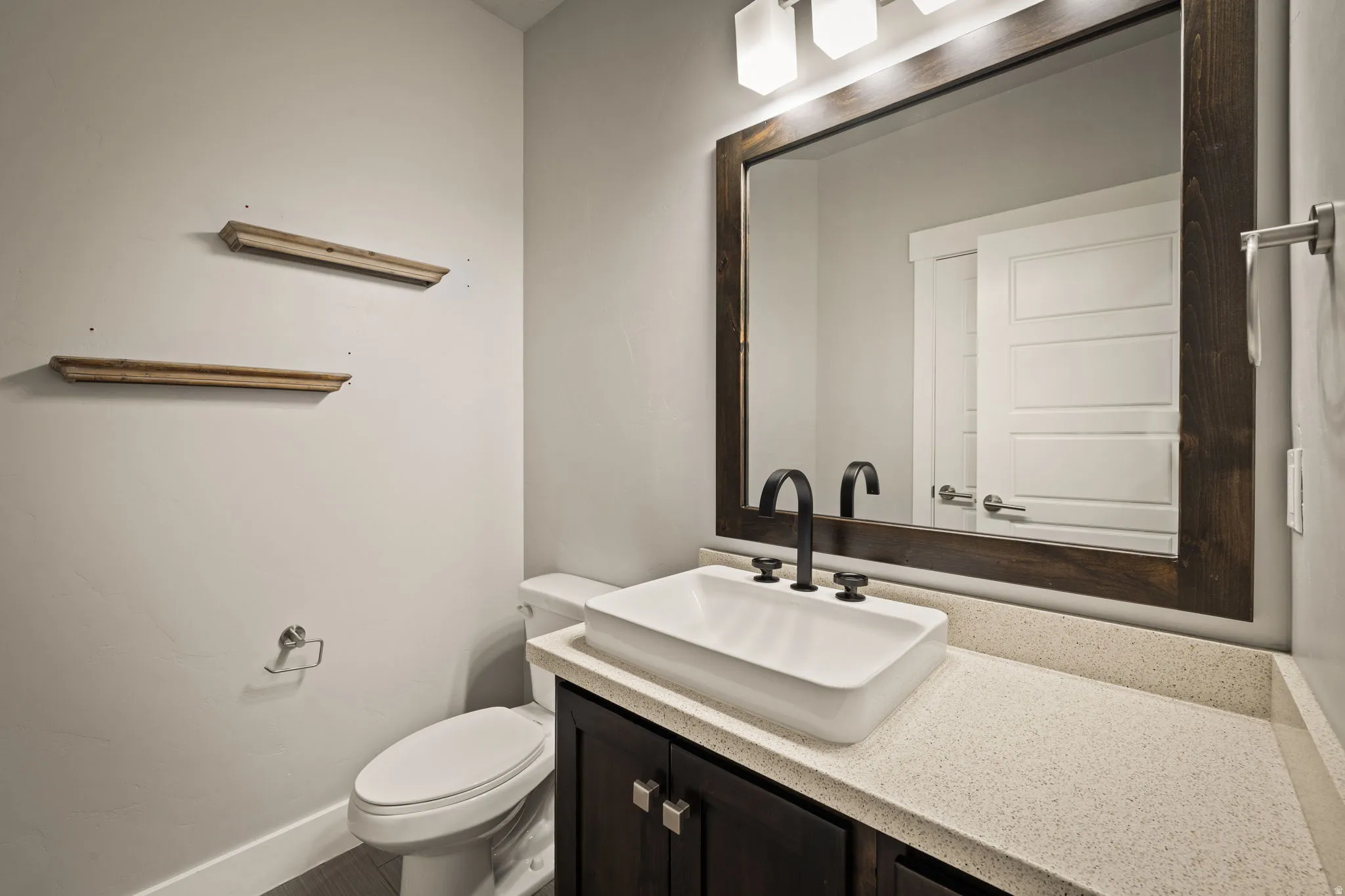 Bathroom featuring vanity and toilet