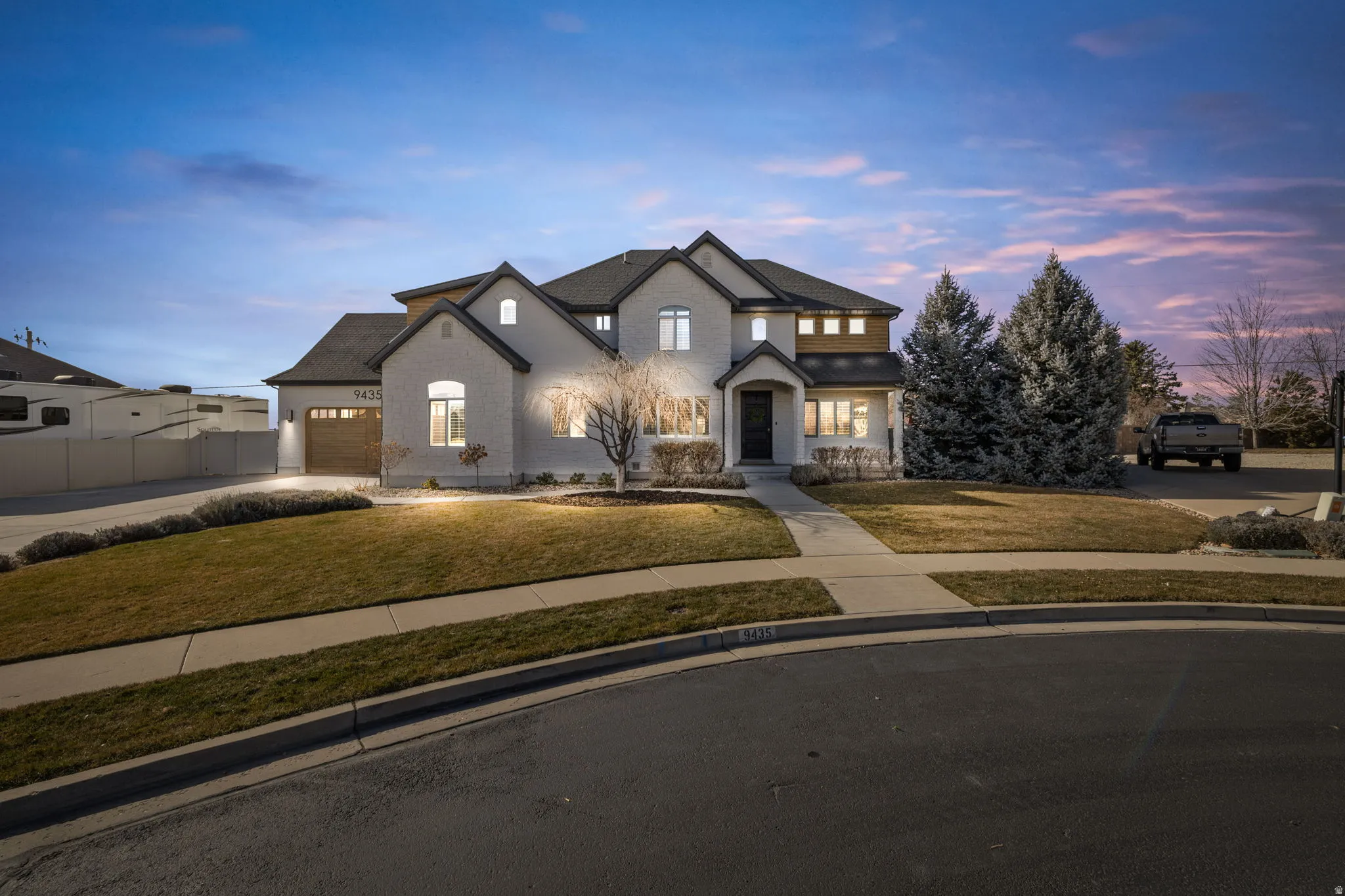 French provincial home featuring concrete driveway and a garage