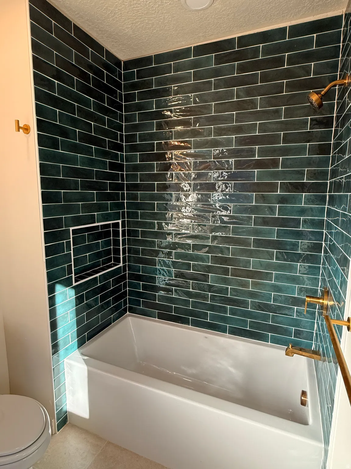 Full bathroom with shower / tub combination, tile patterned flooring, and a textured ceiling