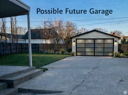 View of yard with an outdoor structure and a garage