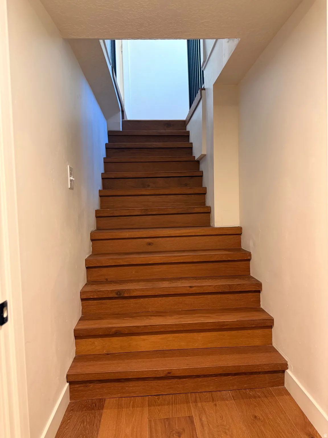 Stairs with baseboards and wood finished floors