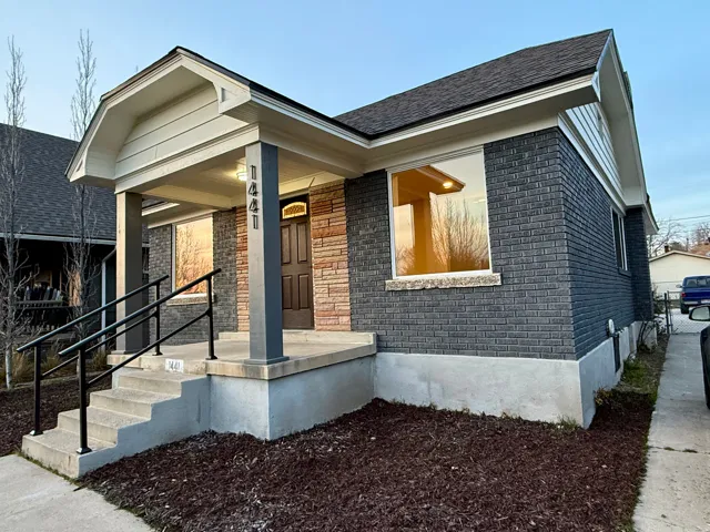 View of front of house with brick siding and covered porch